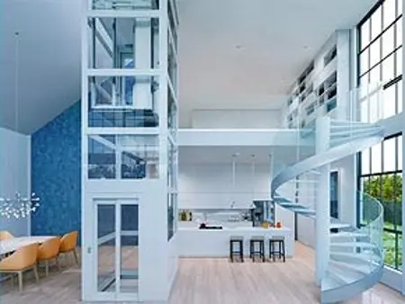 Modern home interior with elevator and spiral staircase. Light wood floors, open concept, high ceilings, bright lighting.